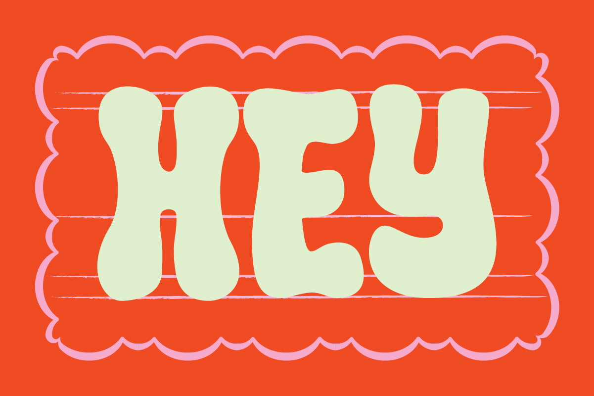The word HEY in cream Crumber bubble lettering inside a red scalloped frame